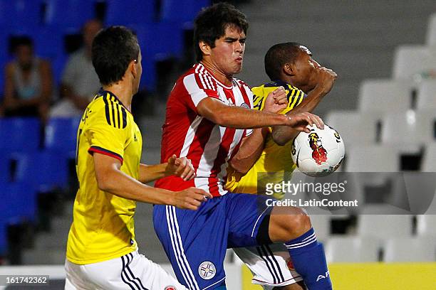 Luis Mena of Colombia struggles for the ball with Brian Montenegro of Paraguay during a match between Colombia and Paraguay as part of the 2013 South...