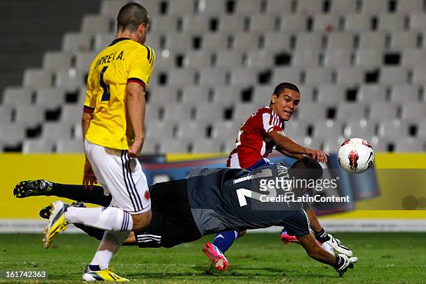 Luis Hurtado , goalkeeper of Colombia struggles for the ball with Brian Montenegro of Paraguay during a match between Colombia and Paraguay as part...