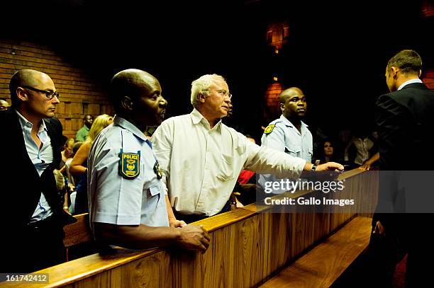 Henke Pistorius reaches out to son Oscar Pistorius during the Pretoria Magistrate court hearing on February 15 in Pretoria, South Africa. Oscar...