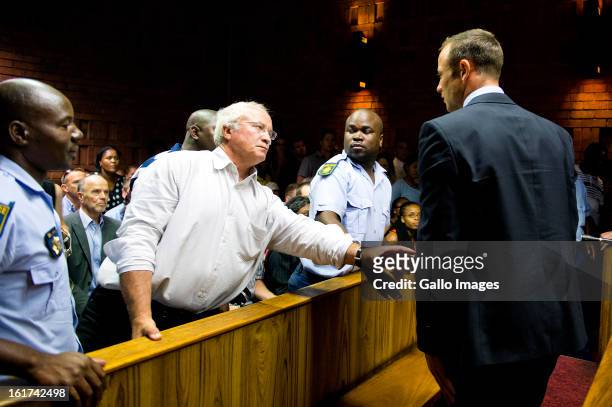 Henke Pistorius reaches out to son Oscar Pistorius during the Pretoria Magistrate court hearing on February 15 in Pretoria, South Africa. Oscar...