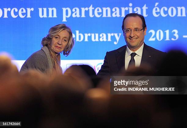 France's Trade Minister Nicole Bricq looks on as France's President Francois Hollande reacts after speaking at the India-France Economic Conference :...