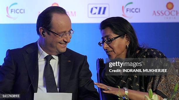 France's President Francois Hollande speaks to Naina Lal Kidwai, President - Federation of Indian Chambers of Commerce and Industry at the...