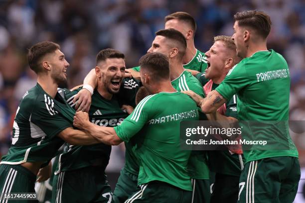 Team mates and staff celebrate with Filip Mladenovic of Panathinaikos FC after he scroed the decisive penalty in the UEFA Champions League Third...