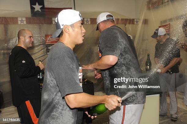 Wei-Yin Chen of the Baltimore Orioles players celebrates with teammates in the clubhouse winning the American League Wild Card game against the Texas...