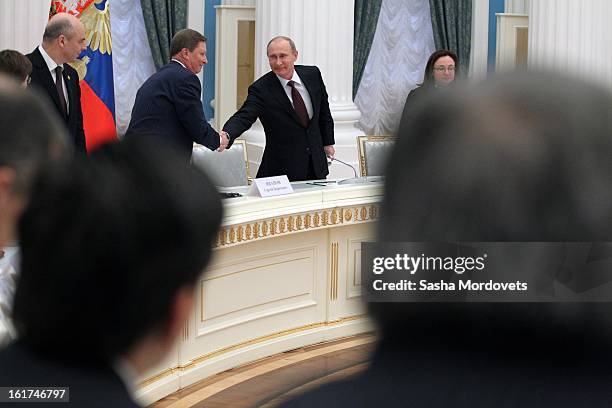 Russian President Vladimir Putin shakes hands with Head of the Presidential Administration Sergey Ivanov during a meeting with G20 finance leaders in...