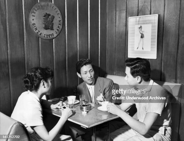 Three citizens enjoy a cup of coffee in a coffee shop in Tokyo, Japan, September 27, 1955. The shops have become increasingly more popular amogst the...