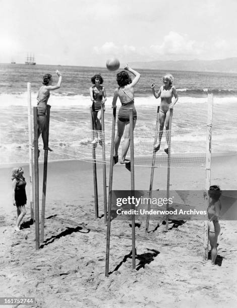 Four young women elevate their game of volleyball by playing it on stilts, Venice, California, June 6, 1934.