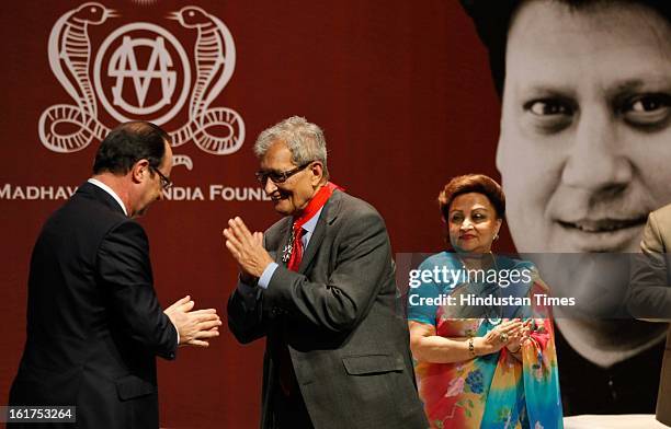 French President Francois Hollande speaks with Indian Nobel laureate Amartya Sen, as wife of late Madhavrao Scindia, Madhavi Raje Scindia looks on,...