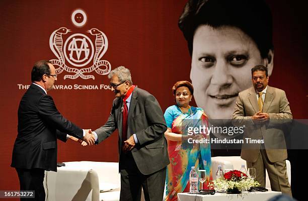 French President Francois Hollande speaks with Indian Nobel laureate Amartya Sen, as wife of late Madhavrao Scindia, Madhavi Raje Scindia and Vir...