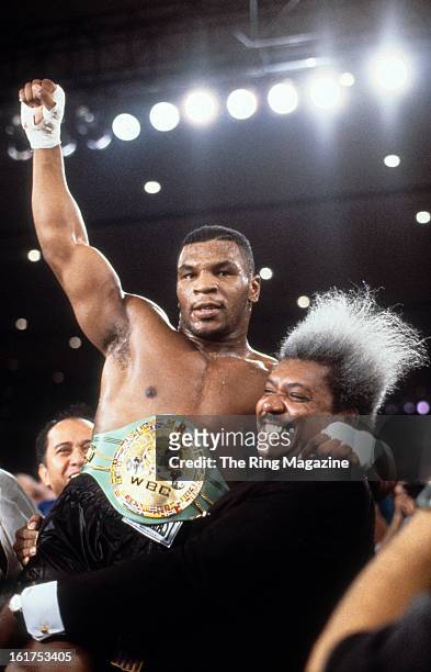 Mike Tyson celebrates with Don King after winning the fight against Trevor Berbick at Hilton Hotel in Las Vegas, Nevada. Mike Tyson won the WBC...