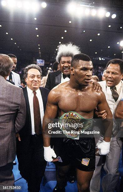 Mike Tyson celebrates with Don King as he wears the belt after winning the fight against Trevor Berbick at Hilton Hotel in Las Vegas, Nevada. Mike...