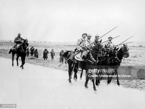 French cavalry patrol passing some British troops on the road on the Western Front, France, May 3, 1918.