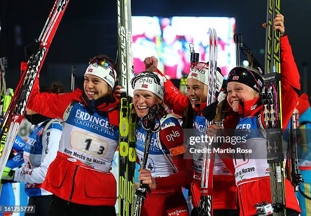 Synnoeve Solemdal, Tora Berger, Ann Kristin Flatland and Hilde Fenne of Norway celebrate after winning the gold medal in the Women's 4 x 6km Relay in...