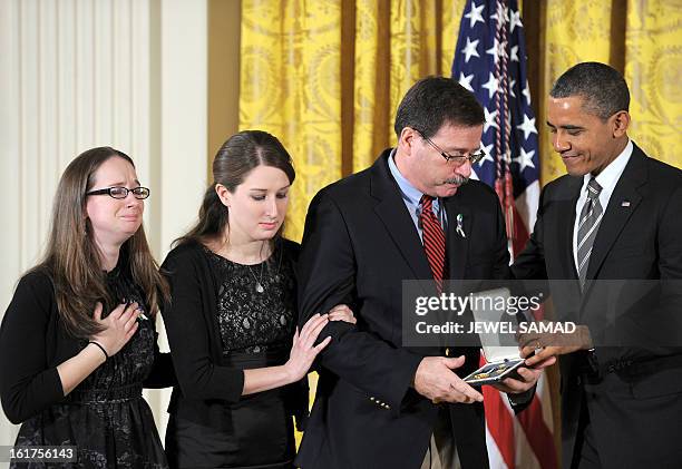 President Barack Obama presents a Citizens Medal to the family of Sandy Hook Elementary School psychologist Mary Sherlach on February 15, 2013 during...