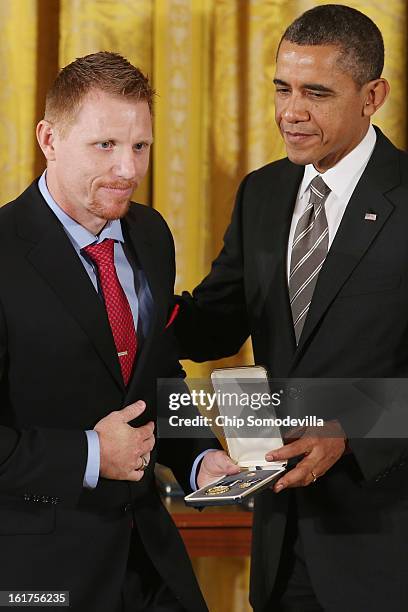 President Barack Obama presents Army veteran and Veterans Farm founder Adam Burke with the 2012 Presidential Citizens Medal, the nation's...