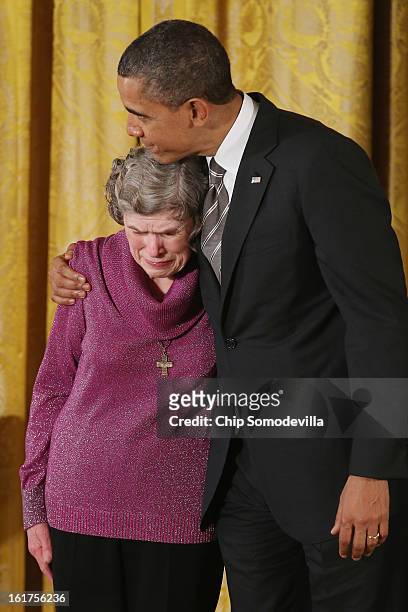 President Barack Obama comforts Sharing and Caring Hands co-founder Mary Jo Copeland before presenting her with the 2012 Presidential Citizens Medal,...