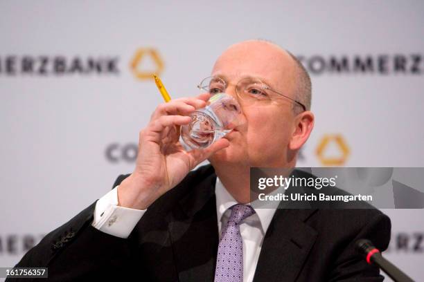 Martin Blessing, CEO of Commerzbank AG, drinks water during the company's annual press conference to present the 2012 results on February 15, 2013 in...