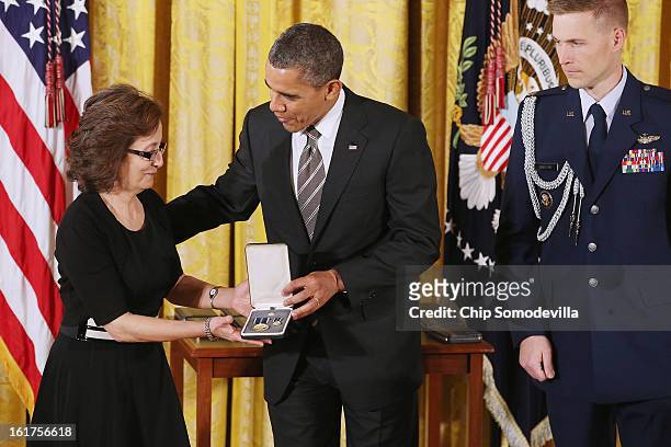 President Barack Obama presents Mary's Center for Maternal and Child Care founder Maria Gomez with the 2012 Presidential Citizens Medal, the nation's...