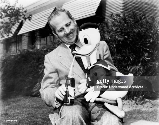 Walt Disney cartoon character Donald Duck enjoys a bottle of the new Donald Duck soft drink being produced by General Beverages, Chattanooga,...