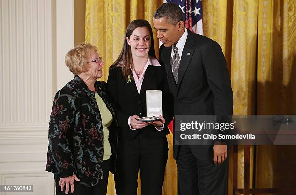 President Barack Obama presents Erica and Cheryl Lafferty with the 2012 Presidential Citizens Medal, the nation's second-highest civilian honor, on...