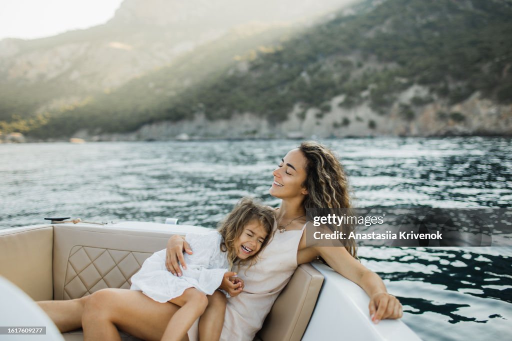 Pleasant young family relaxing on a micro motorboat.
