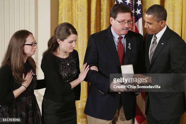 President Barack Obama presents Bill Sherlach and daughters Katy Sherlach and Maura Lynn Schwartz with the 2012 Presidential Citizens Medal, the...