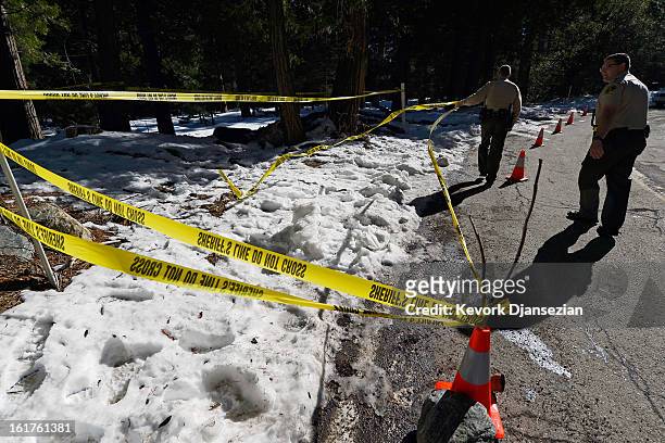 San Bernardino County Sheriff's deputy Alex Cundieff and Chris Kelley secure the scene where a P22 Walther Suppressor hand gun was found in the snow...