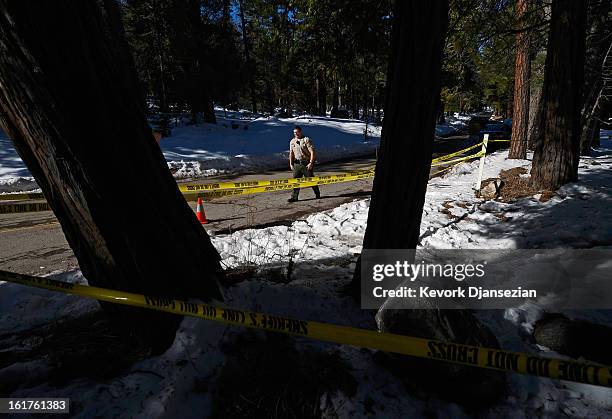 San Bernardino County Sheriff's deputy Alex Cundieff secures the scene where a P22 Walther Suppressor hand gun was found in the snow just off Glass...