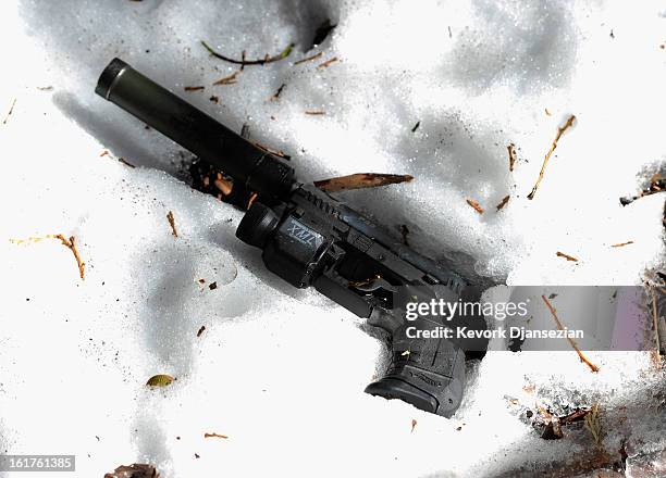 Walther Suppressor hand gun sits in the snow just off Glass Road near where former Los Angeles Police Department officer crashed the purple Nissan...