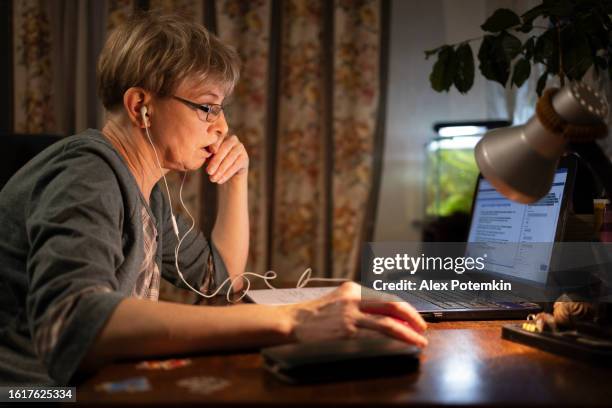 concentrated mature women working from home during pandemic. - alex potemkin coronavirus stock pictures, royalty-free photos & images