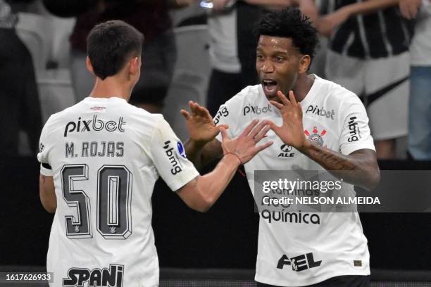 Corinthians' defender Gild celebrates with Corinthians' Paraguayan midfielder Matias Rojas after scoring during the Copa Sudamericana quarterfinals...