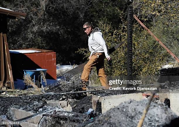 Richard Heltebrake, whose truck was carjacked by multiple murder suspect and former Los Angeles Police Department officer Christopher Dorner, carries...