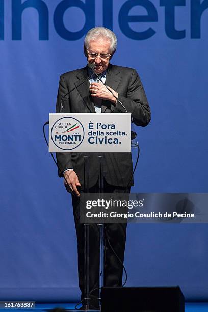 Outgoing Italian Prime Minister Mario Monti gestures as he delivers a speech during a campaign rally for his centrist alliance 'With Monit For Italy'...