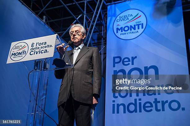 Outgoing Italian Prime Minister Mario Monti gestures as he delivers a speech during a campaign rally for his centrist alliance 'With Monit For Italy'...