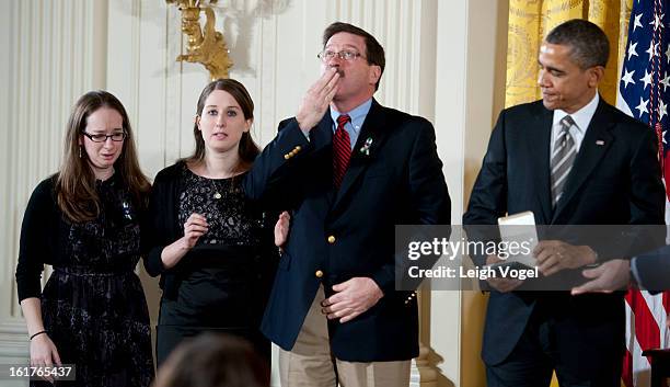 President Barack Obama presents Bill Sherlach and daughters Katy Sherlach and Maura Lynn Schwartz with the 2012 Presidential Citizens Medal, the...