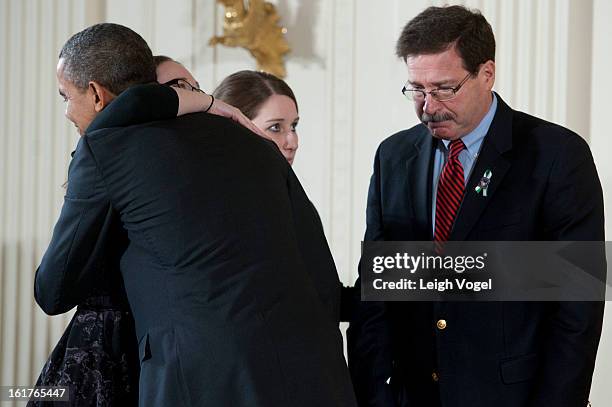 President Barack Obama presents Bill Sherlach and daughters Katy Sherlach and Maura Lynn Schwartz with the 2012 Presidential Citizens Medal, the...