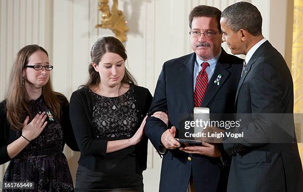 President Barack Obama presents Bill Sherlach and daughters Katy Sherlach and Maura Lynn Schwartz with the 2012 Presidential Citizens Medal, the...