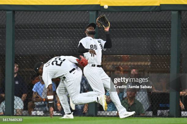 Luis Robert Jr. #88 of the Chicago White Sox chases down a deep fly ball as Oscar Colas ducks out of the way in the second inning against the Seattle...