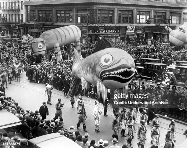 Part of the Thanksgiving Day Parade that officially brings Santa Claus into the Metropolis, New York, New York, late 1920s. The Fish Balloon is 35...
