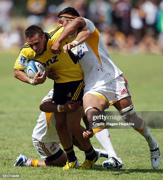 Andre Taylor of the Hurricanes is tackled during the Super Rugby trial match between the Hurricanes and the Chiefs at Mangatainoka RFC on February...