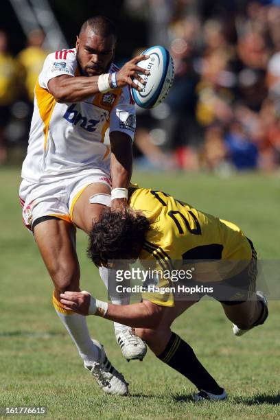 Patrick Osborne of the Chiefs is tackled by Richard Buckman of the Hurricanes during the Super Rugby trial match between the Hurricanes and the...