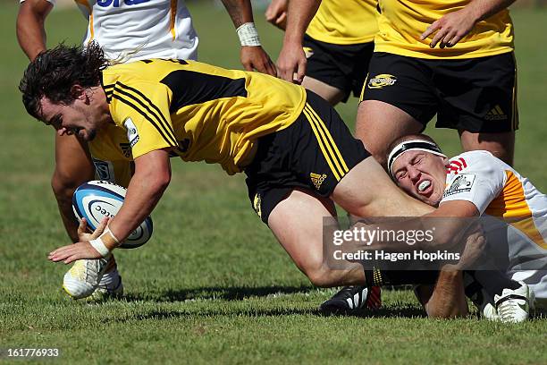 Richard Buckman of the Hurricanes is tackled by Brodie Retallick of the Chiefs during the Super Rugby trial match between the Hurricanes and the...