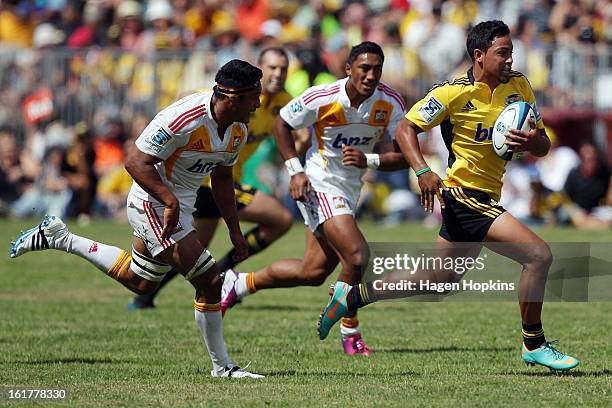 Matt Proctor of the Hurricanes is chased by Tanerau Latimer of the Chiefs during the Super Rugby trial match between the Hurricanes and the Chiefs at...