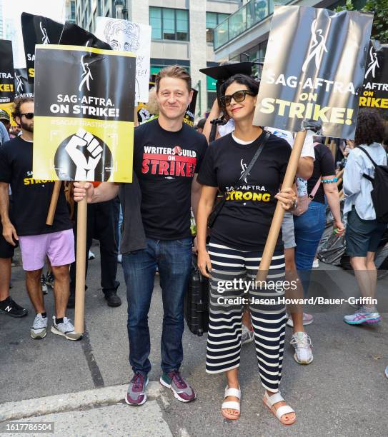 Ben McKenzie and Morena Baccarin are seen on the SAG-AFTRA picket line on August 22, 2023 in New York City.