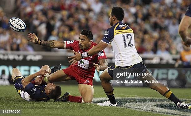 Digby Ioane of the Reds is tackled by Clyde Rathbone of the Brumbies during the round 1 Super Rugby match between the Brumbies and the Reds at...