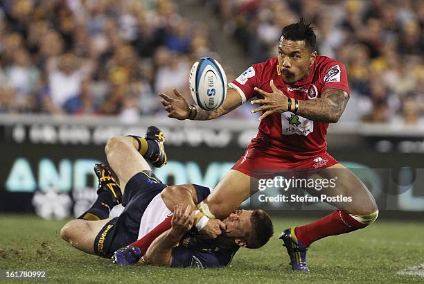 Digby Ioane of the Reds is tackled by Clyde Rathbone of the Brumbies during the round 1 Super Rugby match between the Brumbies and the Reds at...
