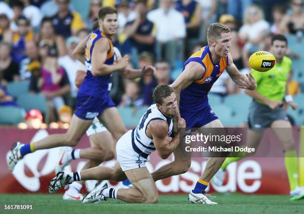 Joel Selwood of the Geelong Cats tackles his brother Adam Selwood of the West Coast Eagles during the round one NAB Cup AFL match between the West...