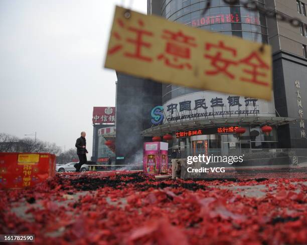 Fireworks are seen after lighting on a road on February 16, 2013 in Taiyuan, Shanxi Province of China. Local businesses in China rushed to set off...