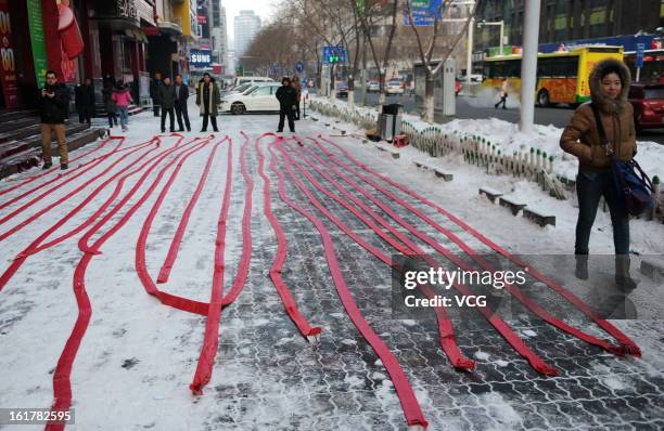 Fireworks are seen before lighting on a road on February 16, 2013 in Urumqi, Sinkiang Province of China. Local businesses in China rushed to set off...