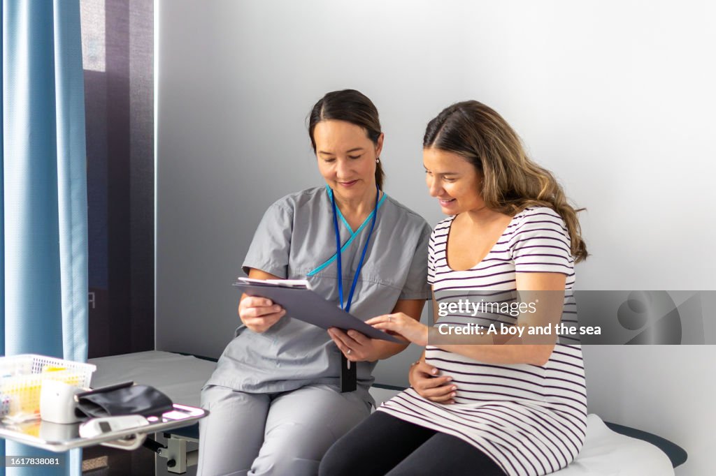 Expectant Mother Consults Test Findings with Compassionate Nurse